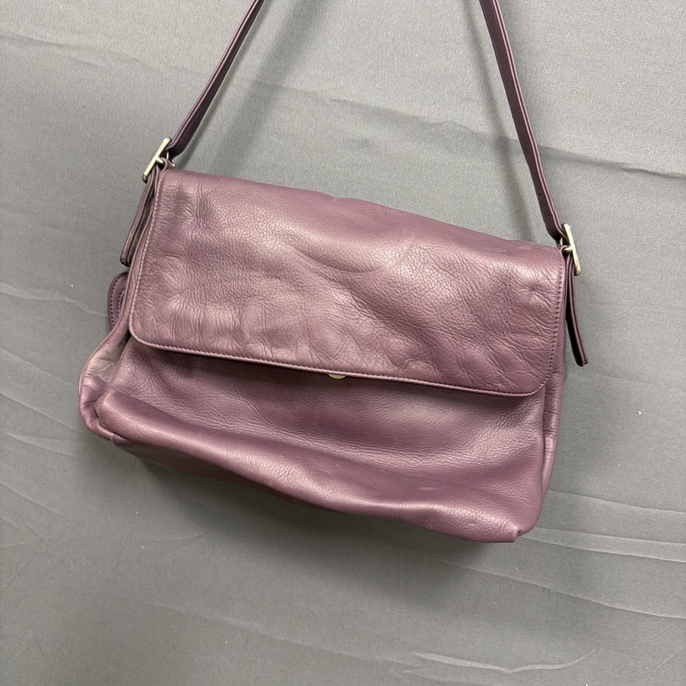 purple Apostrophe leather shoulder bag features a magnetic snap closure